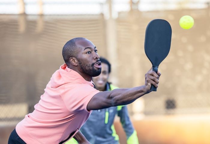 man hitting ball with bat