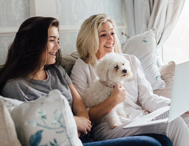 mother and daughter on laptop reading about Child Trust Funds