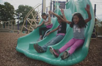 Families of foresters members playing in a playground