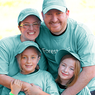 man woman and two daughters wearing Foresters Financial t-shirts and hats