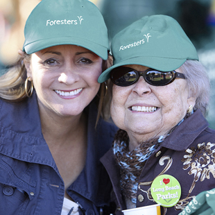 happy women smiling wearing Foresters hats 