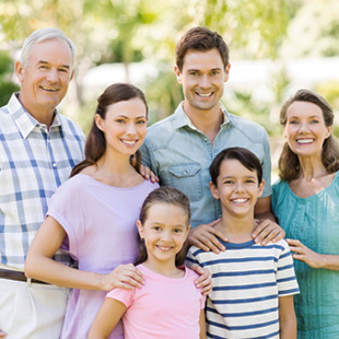 multigeneration family smiling and posing together