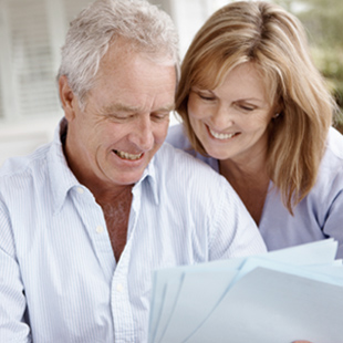 Mature couple reading papers