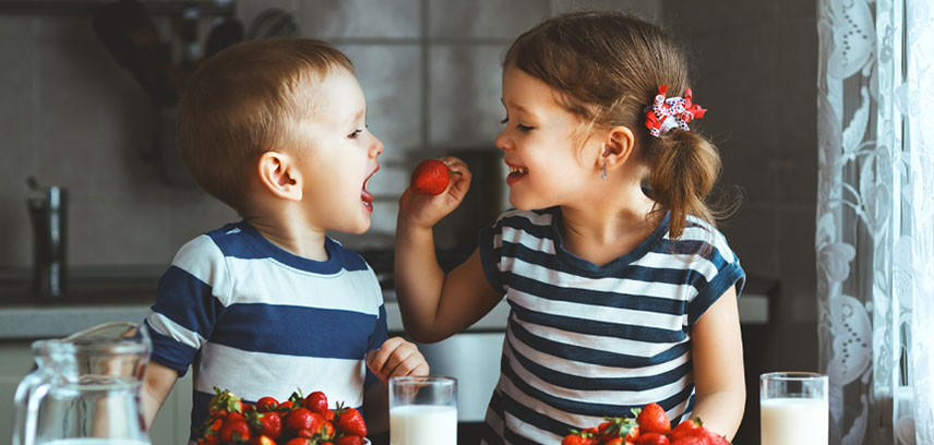 Children playing with strawberries