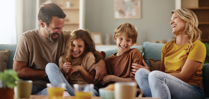 Caucasian family on the sofa, laughing together