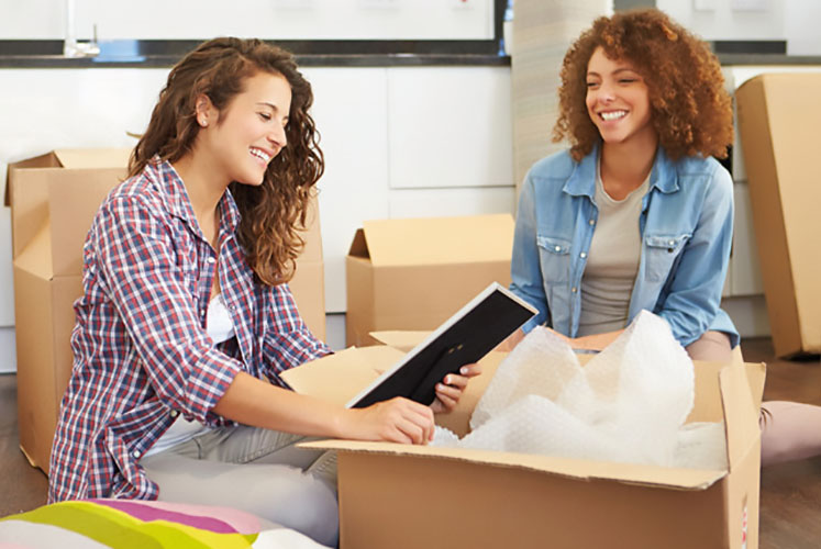 Girls unpacking after using their lifetime ISA to buy their first home