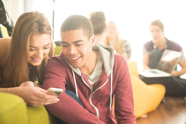 18 year old boy and girl looking at MyPlans on their phone